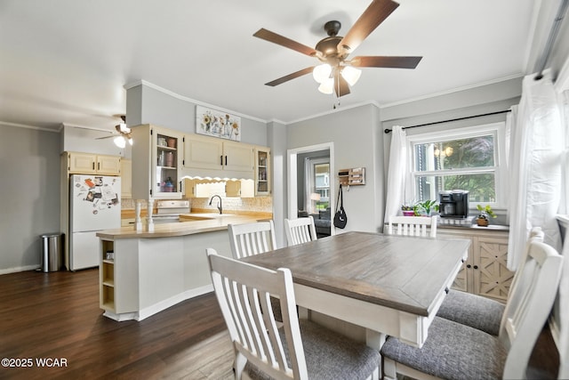 307 N Jefferson St, Van Wert, OH 45891 - dining space featuring a ceiling fan, crown molding, and dark wood finished floors