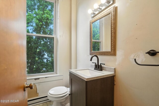 307 N Jefferson St, Van Wert, OH 45891 - half bathroom with baseboard heating, vanity, and plenty of natural light