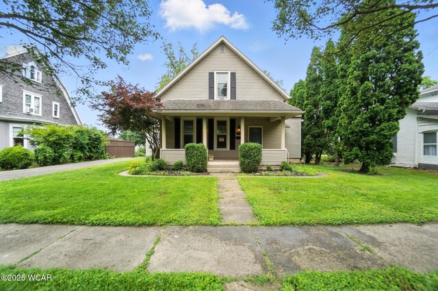 307 N Jefferson St, Van Wert, OH 45891 - bungalow-style home featuring covered porch and a front lawn