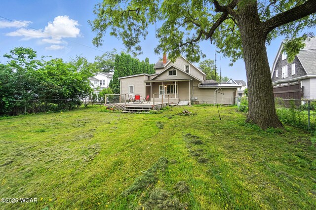 307 N Jefferson St, Van Wert, OH 45891 - back of property featuring a fenced backyard, a wooden deck, and a chimney