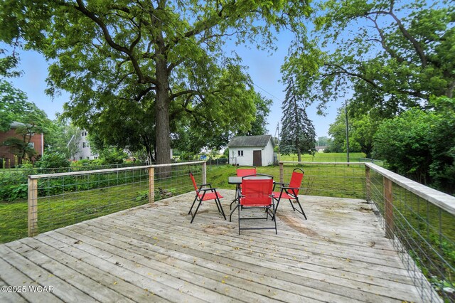 307 N Jefferson St, Van Wert, OH 45891 - wooden deck with outdoor dining space and a shed