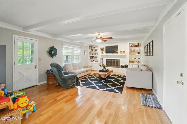 2357 London Dr, Lima, OH 45805 - living area with beamed ceiling, wood finished floors, baseboards, plenty of natural light, and ceiling fan