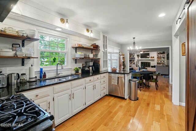 2357 London Dr, Lima, OH 45805 - kitchen with stainless steel dishwasher, open shelves, a sink, a chandelier, and recessed lighting