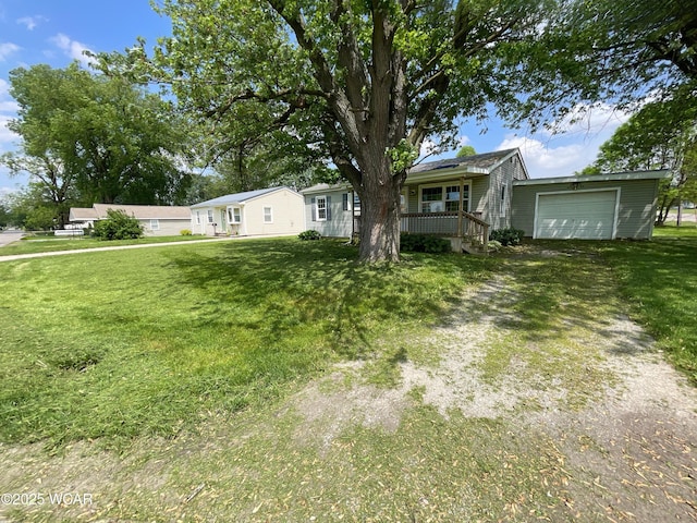 635 Stevens St, Kenton, OH 43326 - view of front of home featuring a front lawn, driveway, an attached garage, and a porch