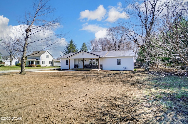 view of front of property featuring metal roof and a porch