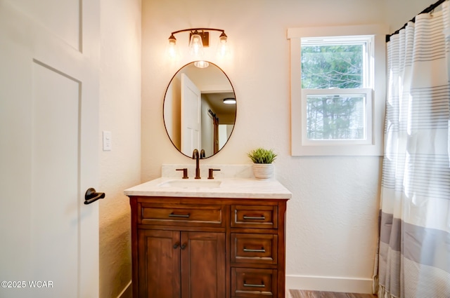 bathroom with baseboards and vanity
