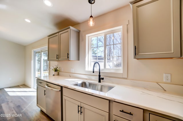 kitchen with a sink, pendant lighting, wood finished floors, stainless steel dishwasher, and recessed lighting