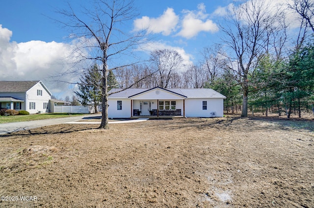 view of front of home featuring metal roof and a porch