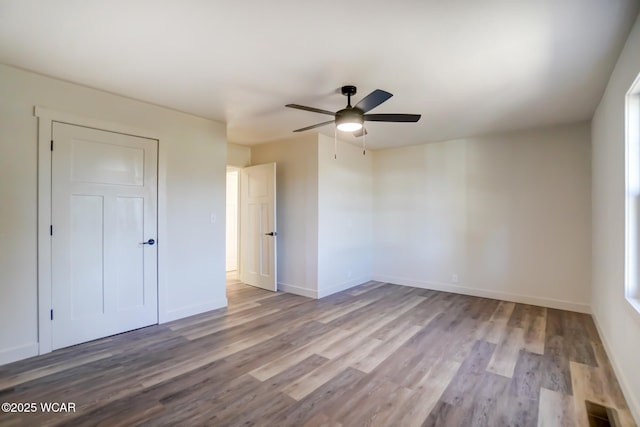 unfurnished bedroom with baseboards, ceiling fan, and wood finished floors