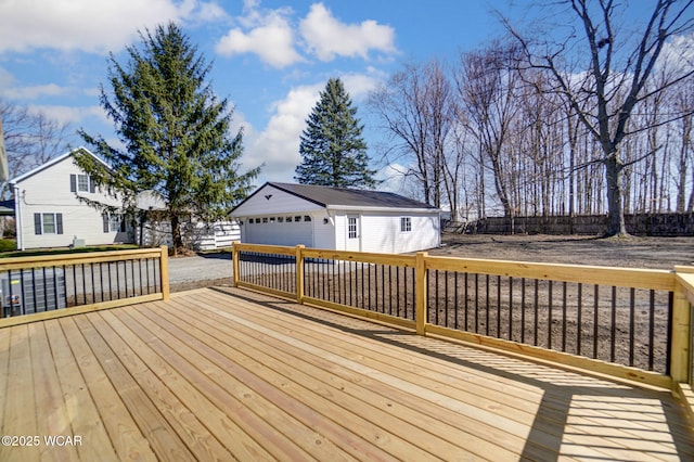 wooden terrace with an outdoor structure, fence, and a detached garage