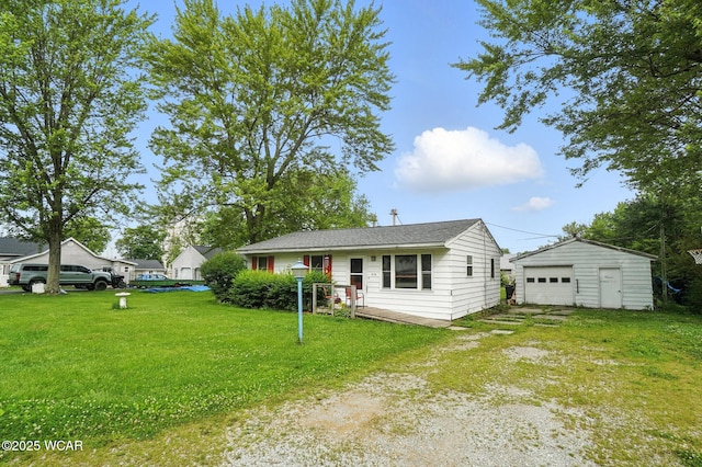 5176 Norfolk St, Lima, OH 45806 - view of front of home with a detached garage, a front yard, an outbuilding, and driveway