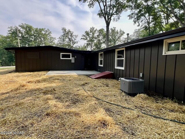 1271 Forest Dr, Lima, OH 45805 - rear view of property with board and batten siding and a patio area