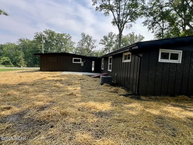 1271 Forest Dr, Lima, OH 45805 - view of side of home featuring board and batten siding and a central air condition unit