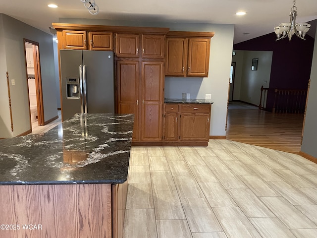 1421 Krendl Dr, Van Wert, OH 45891 - kitchen featuring stainless steel refrigerator with ice dispenser, a chandelier, brown cabinets, dark stone countertops, and recessed lighting
