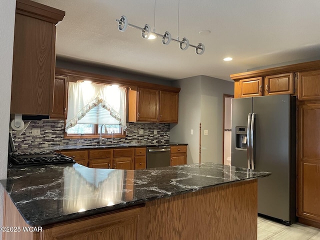 1421 Krendl Dr, Van Wert, OH 45891 - kitchen featuring stainless steel appliances, a sink, tasteful backsplash, a peninsula, and dark stone countertops