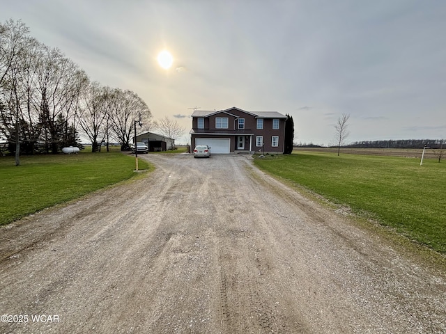 view of front of home with driveway, an attached garage, and a front lawn