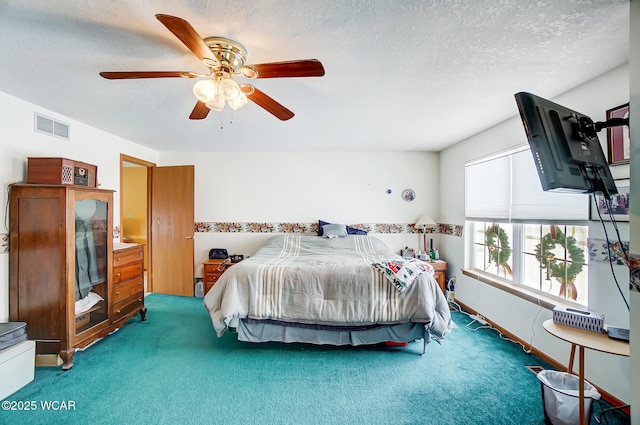 carpeted bedroom with a textured ceiling, ceiling fan, and visible vents