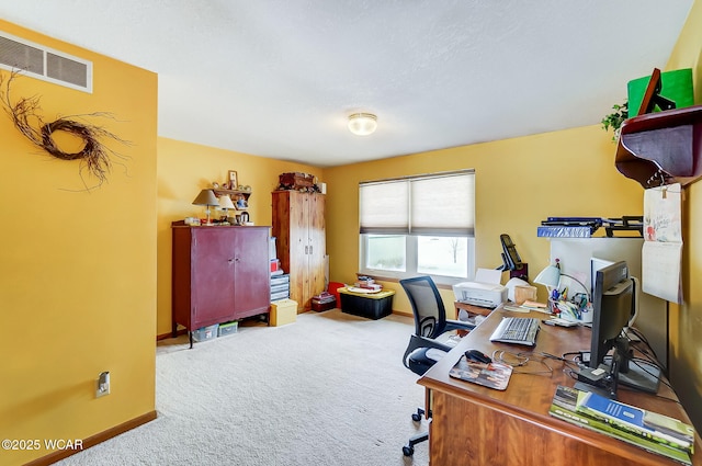 carpeted office with baseboards and visible vents
