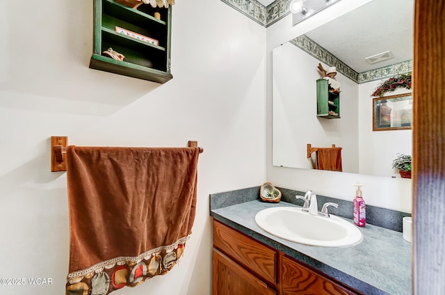 bathroom with visible vents and vanity