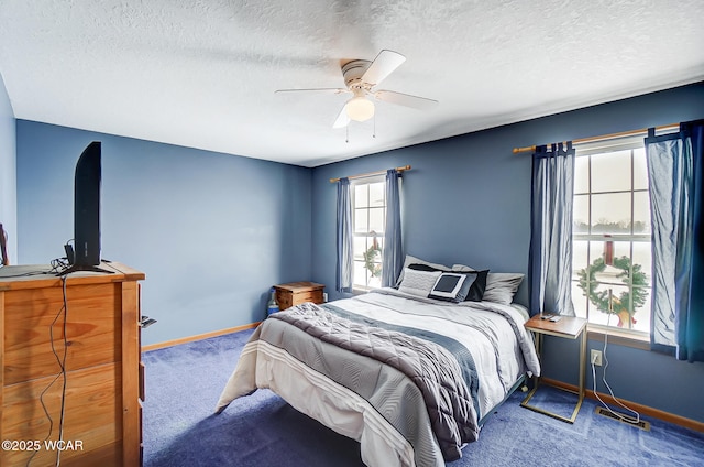 carpeted bedroom with baseboards, a textured ceiling, and a ceiling fan