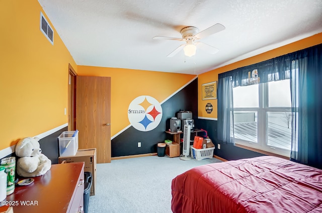 carpeted bedroom featuring baseboards, visible vents, and ceiling fan