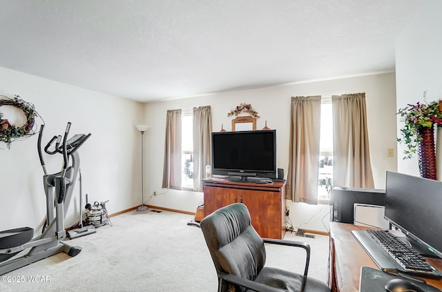 carpeted home office featuring baseboards and a healthy amount of sunlight