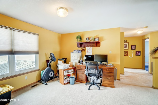 office area featuring baseboards, visible vents, and carpet floors