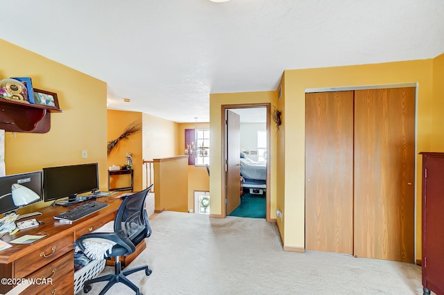 carpeted office space featuring baseboards