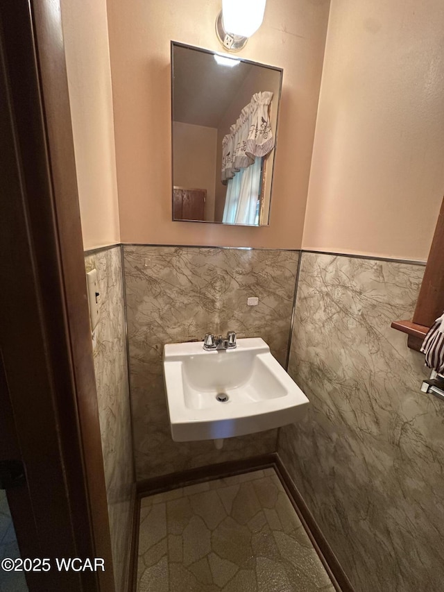 1115 Fett Ave, Lima, OH 45801 - bathroom with wainscoting, tile walls, a sink, and tile patterned flooring