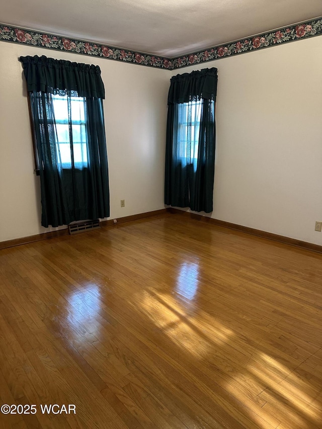 1115 Fett Ave, Lima, OH 45801 - empty room featuring wood finished floors, healthy amount of natural light, and baseboards