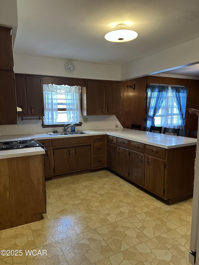 1115 Fett Ave, Lima, OH 45801 - kitchen with a sink, light countertops, a peninsula, and stovetop