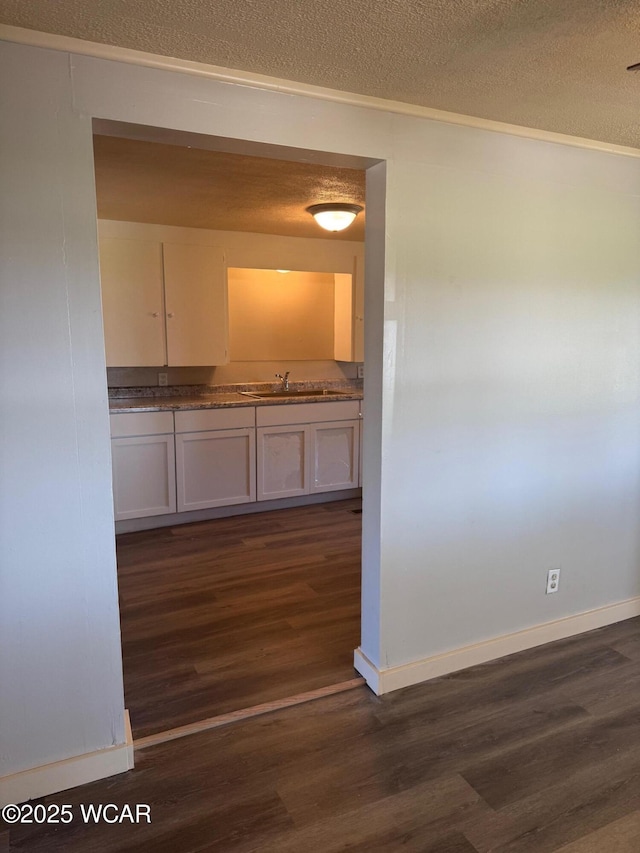 138 Letson Ave, Kenton, OH 43326 - hall with dark wood-style flooring, a sink, a textured ceiling, baseboards, and crown molding