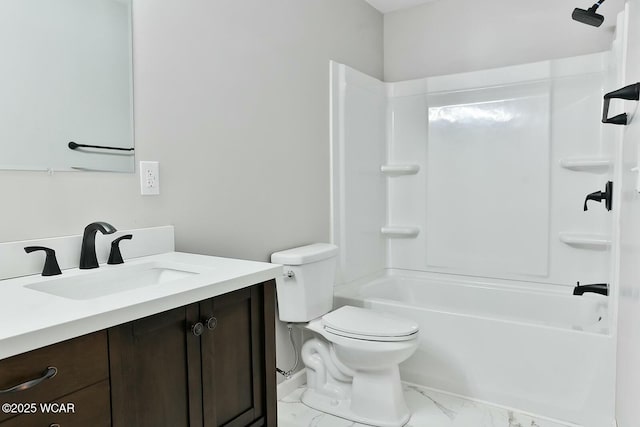 full bathroom featuring marble finish floor, washtub / shower combination, toilet, and vanity