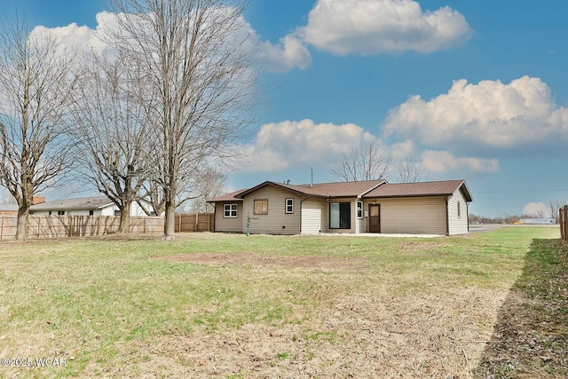 single story home with fence and a front lawn