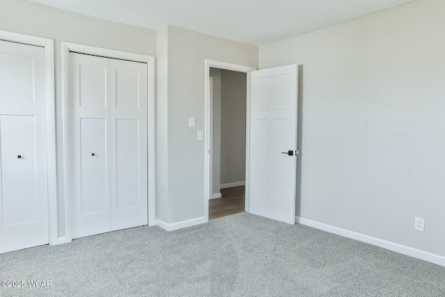unfurnished bedroom with baseboards and carpet flooring