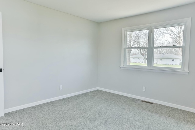 carpeted empty room with baseboards and visible vents