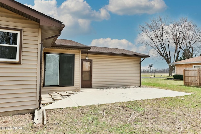 property entrance featuring a patio, fence, and a yard