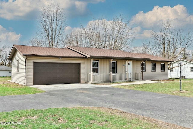 ranch-style house featuring driveway, a garage, a porch, and a front yard