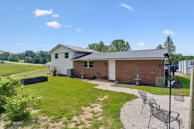 2855 State Route 67, Belle Center, OH 43310 - back of property with cooling unit, a yard, metal roof, and brick siding