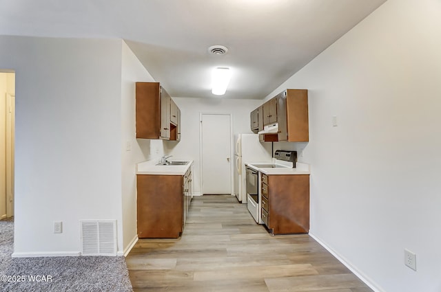 kitchen featuring sink, white electric range, and light hardwood / wood-style floors