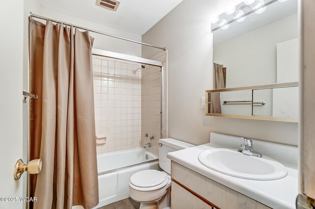 full bathroom featuring vanity, shower / bath combination with curtain, and toilet