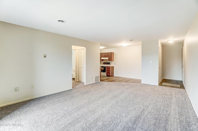 unfurnished living room with light colored carpet