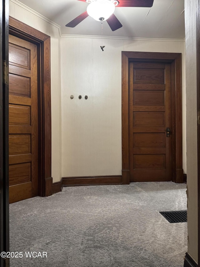 corridor featuring crown molding and carpet