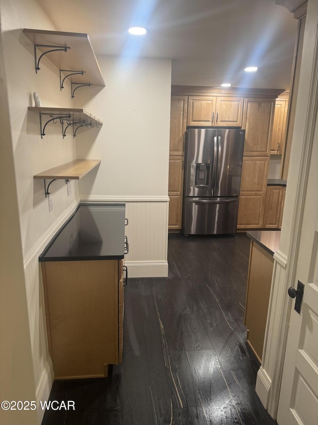 kitchen with dark hardwood / wood-style flooring and stainless steel fridge