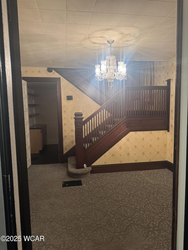 interior space with a notable chandelier and carpet