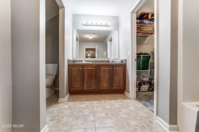 bathroom with vanity, tile patterned floors, and toilet