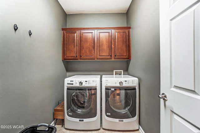 washroom featuring cabinets and separate washer and dryer