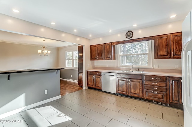 kitchen with baseboards, a sink, pendant lighting, stainless steel dishwasher, and a chandelier