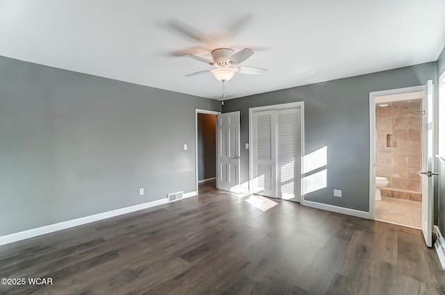 unfurnished bedroom with visible vents, baseboards, dark wood finished floors, ceiling fan, and a closet