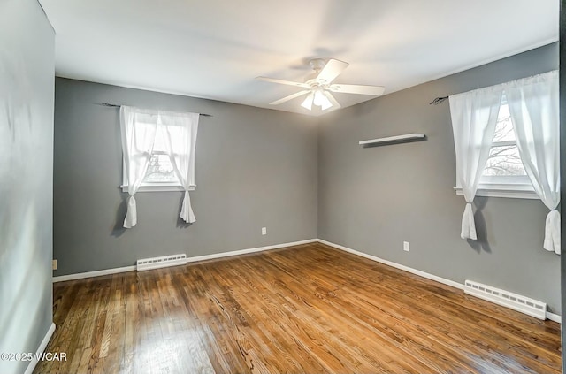 unfurnished room with visible vents, baseboards, a ceiling fan, and wood finished floors